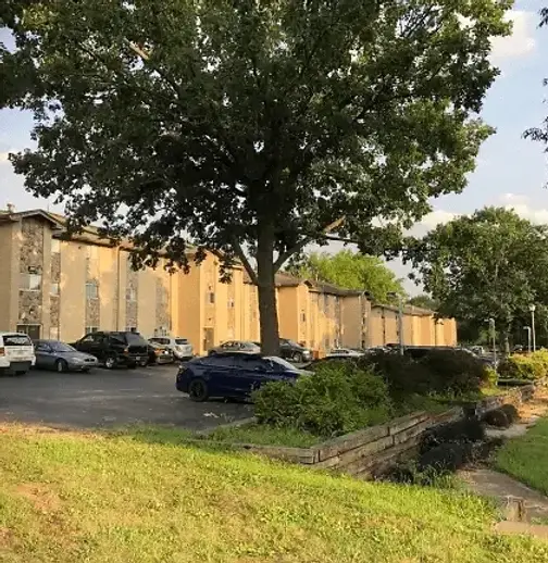 Anndell Park Apartments exterior with mature trees and lawn