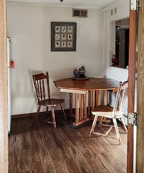 Dining area with wood table and hard-surface flooring at Anndell Park Apartments